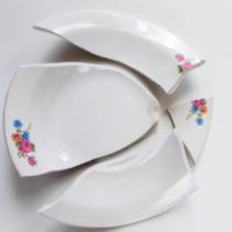 Bord met bloemen in stukken als symbool voor relatiebreuk in Gieten